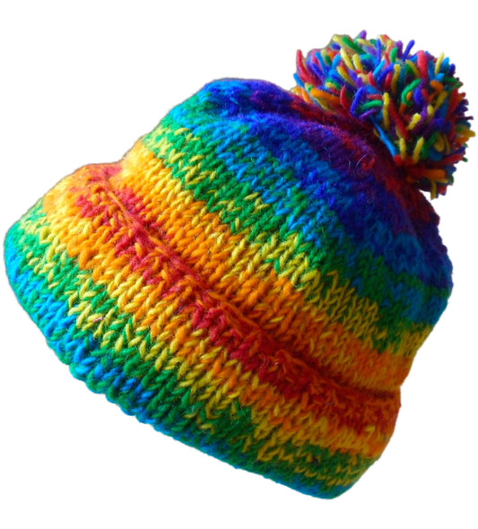 Main image of fleece lined rainbow space dye effect beanie hat finished with a generous pom pom & has a fold back brim. Hand knitted in Nepal. One size.