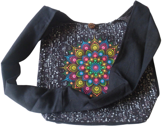 Black cotton shoulder bag with stunning rainbow mandala screen print. The rainbow mandala design is screen printed on heavy weight cotton to the front of the bag with the background design printed with stars & swirls. Plain cotton weave to back of bag. Fully lined. Zip to inside top of bag & single wooden button fastening. One inside pocket with zip fastening.